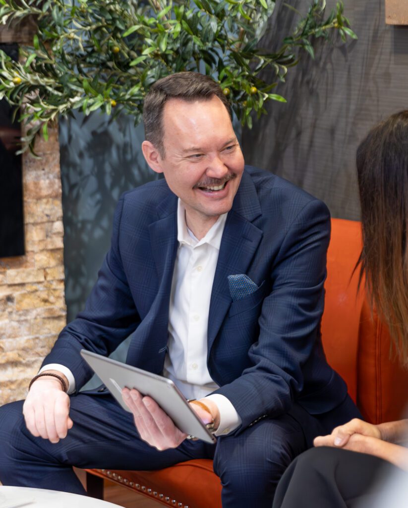 Man in suit smiling during meeting