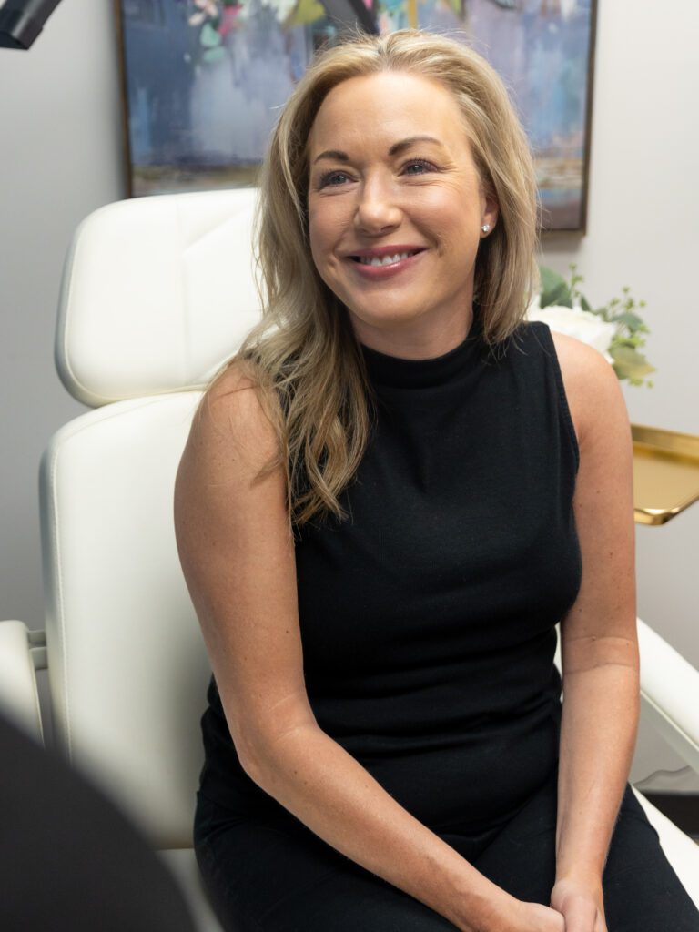 A woman is smiling before her treatment for ATTIVA skin tightening in Fort Collins.
